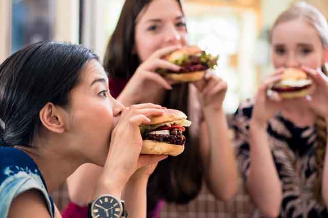 Getting Back into Ketosis after a cheat day - women eating hamburgers